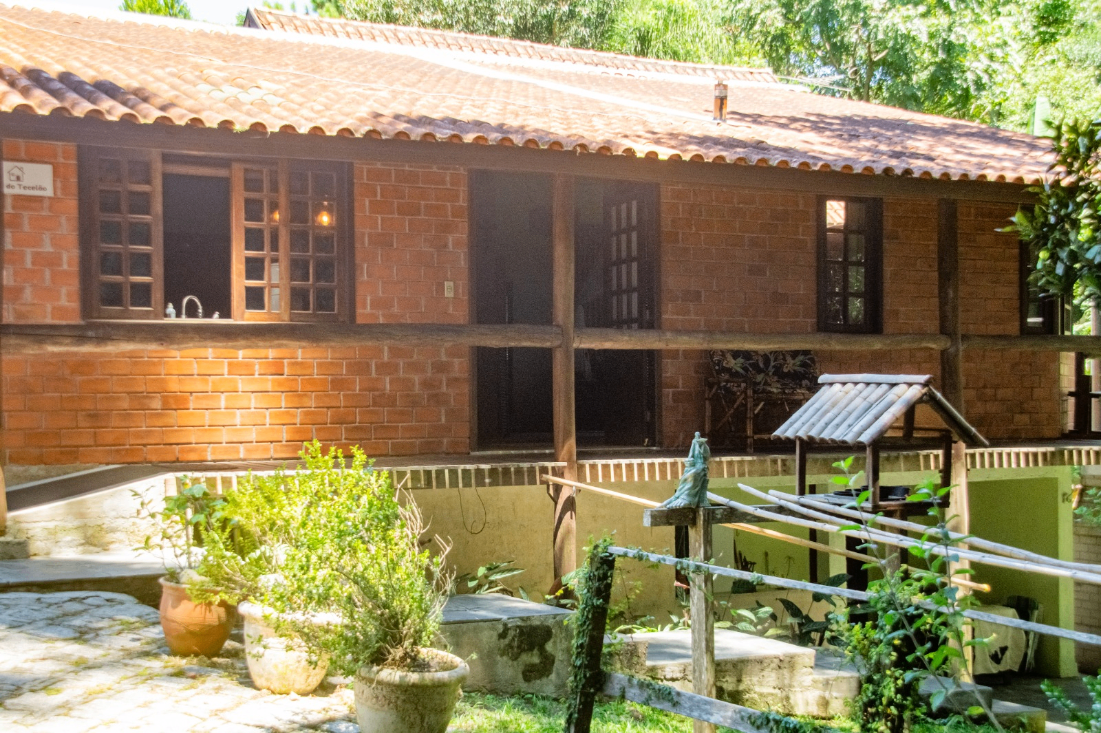 Fachada da casa em tijolo aparente vista do pátio